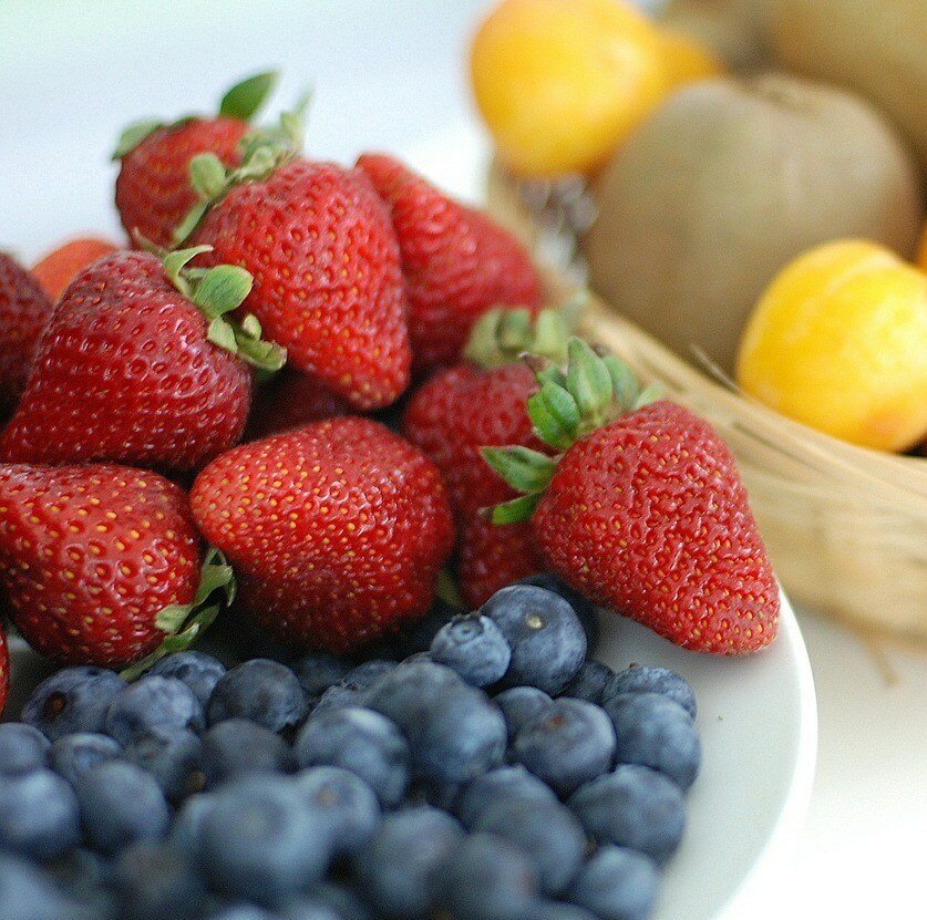 Primary Colors as shown in fruit, red strawberries, yellow lemons and blueberries